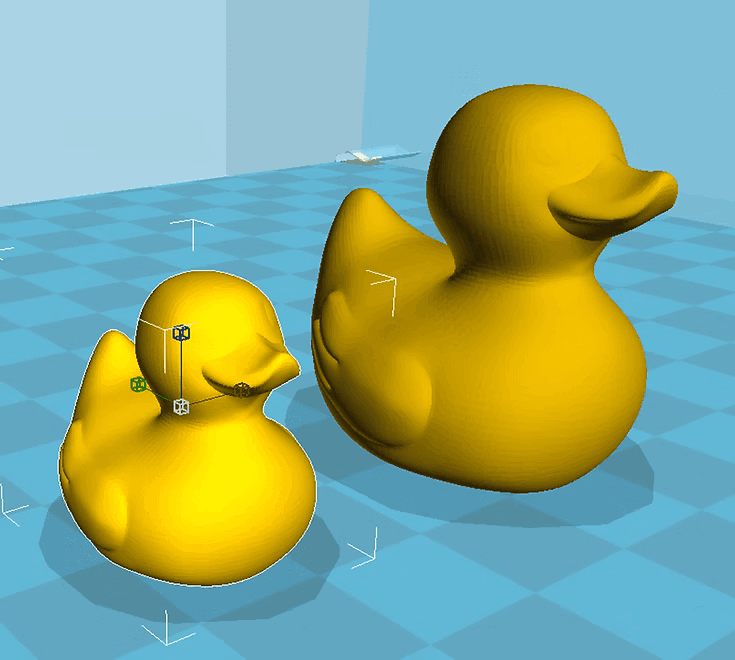 The duck model loaded into Cura, shown twice at different scales on the printer build plate ready for slicing
